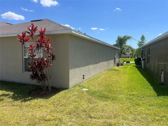 view of property exterior with a lawn and stucco siding