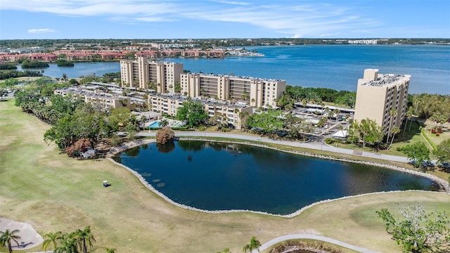 birds eye view of property with a water view and a view of city