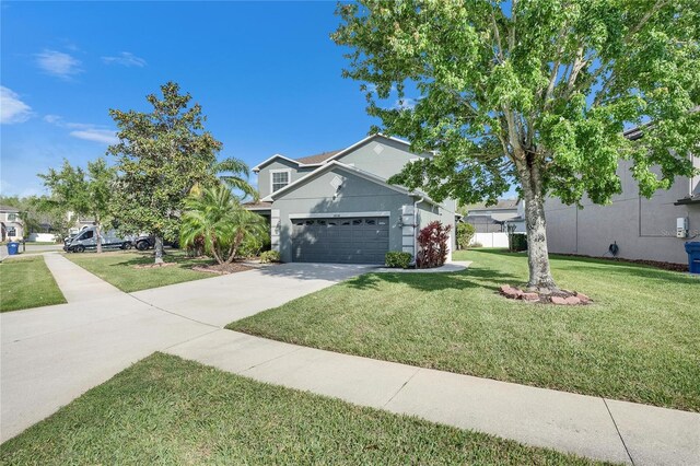 18734 Burndall Ct, Land O Lakes, FL 34638 - traditional-style house with stucco siding, a garage, a front yard, and concrete driveway