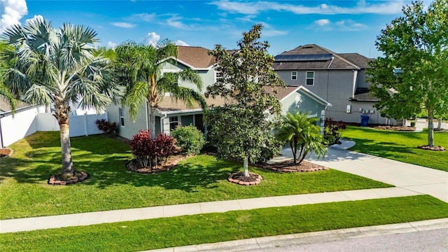 18734 Burndall Ct, Land O Lakes, FL 34638 - view of front of home with concrete driveway, a front lawn, fence, and stucco siding