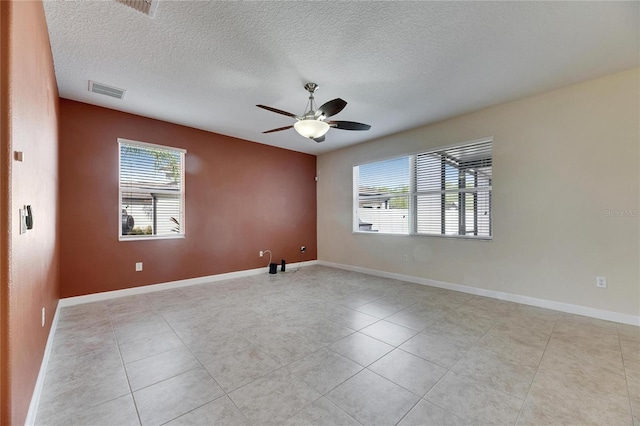 18734 Burndall Ct, Land O Lakes, FL 34638 - empty room featuring visible vents, baseboards, ceiling fan, and a healthy amount of sunlight