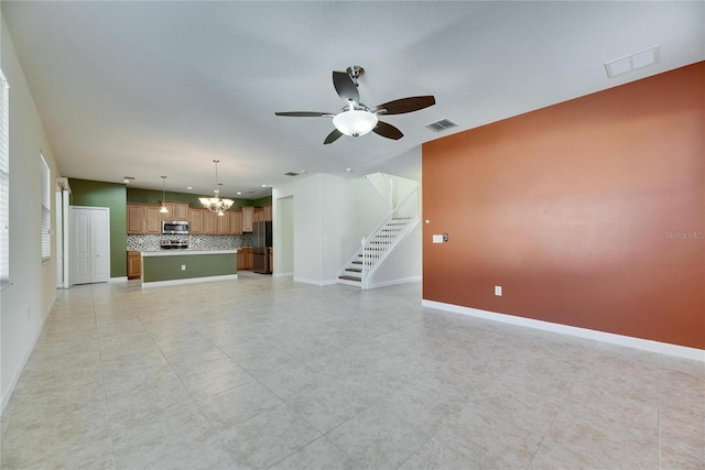18734 Burndall Ct, Land O Lakes, FL 34638 - unfurnished living room with stairway, baseboards, visible vents, and ceiling fan with notable chandelier