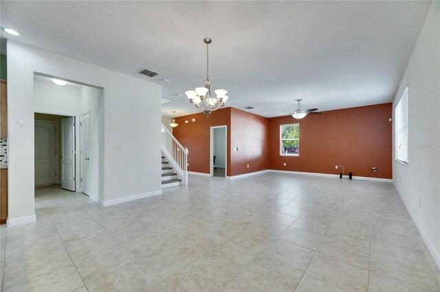 18734 Burndall Ct, Land O Lakes, FL 34638 - unfurnished room with baseboards, visible vents, ceiling fan with notable chandelier, stairway, and light tile patterned floors