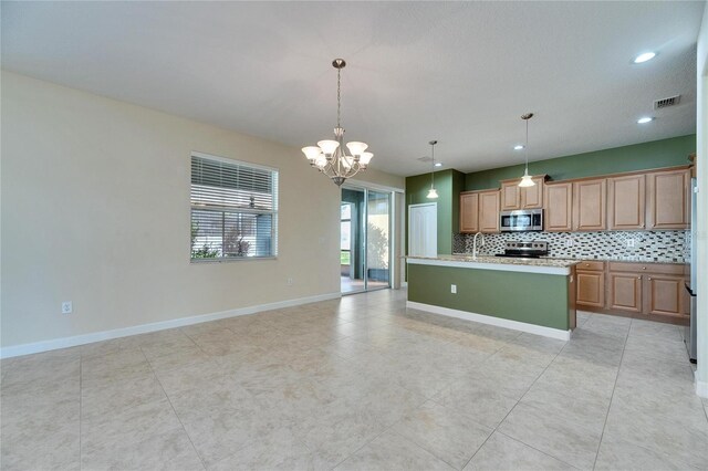 18734 Burndall Ct, Land O Lakes, FL 34638 - kitchen with a sink, decorative backsplash, appliances with stainless steel finishes, a notable chandelier, and visible vents