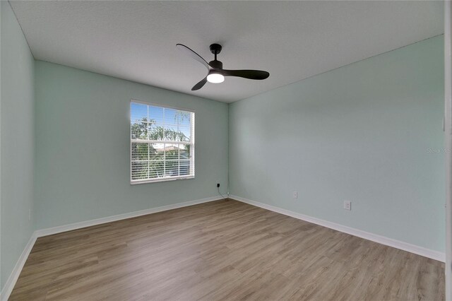 18734 Burndall Ct, Land O Lakes, FL 34638 - empty room featuring light wood-type flooring, baseboards, and ceiling fan