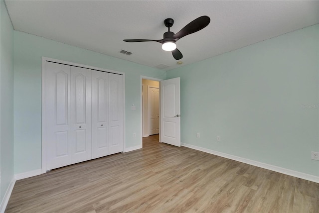 18734 Burndall Ct, Land O Lakes, FL 34638 - unfurnished bedroom with baseboards, light wood-style floors, and a closet
