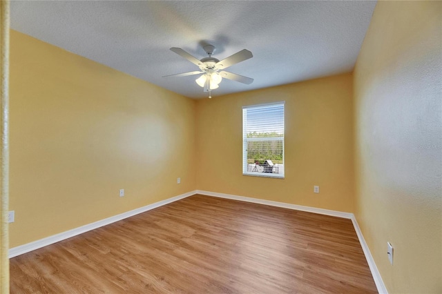 18734 Burndall Ct, Land O Lakes, FL 34638 - spare room with light wood-style floors, a textured ceiling, baseboards, and ceiling fan