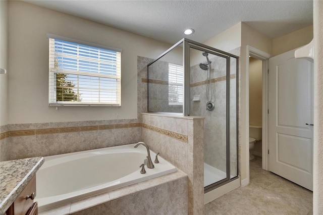 18734 Burndall Ct, Land O Lakes, FL 34638 - bathroom with tile patterned floors, a stall shower, a bath, vanity, and toilet