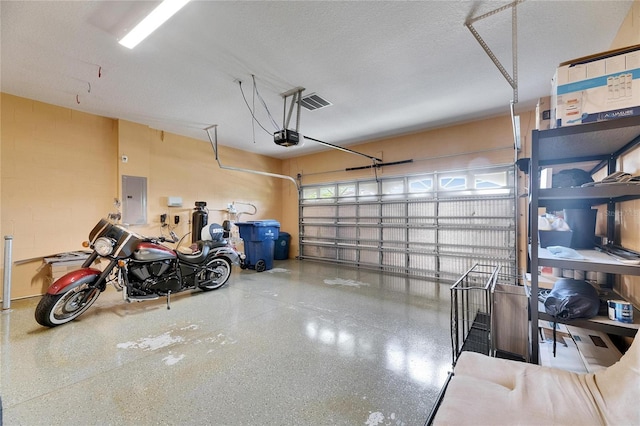 18734 Burndall Ct, Land O Lakes, FL 34638 - garage featuring electric panel and a garage door opener
