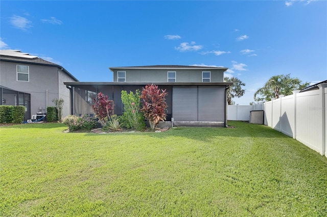 18734 Burndall Ct, Land O Lakes, FL 34638 - rear view of house featuring cooling unit, a lawn, and a fenced backyard