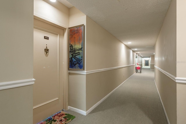 30 Turner St Unit 502, Clearwater, FL 33756 - hall featuring baseboards, carpet, and a textured ceiling