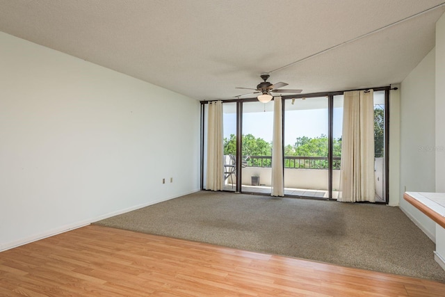 30 Turner St Unit 502, Clearwater, FL 33756 - unfurnished room with a textured ceiling, baseboards, floor to ceiling windows, a ceiling fan, and light wood-style floors