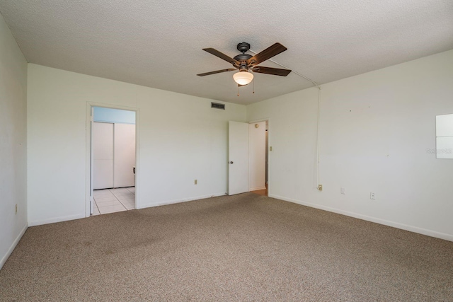 30 Turner St Unit 502, Clearwater, FL 33756 - empty room featuring light colored carpet, baseboards, a textured ceiling, visible vents, and a ceiling fan
