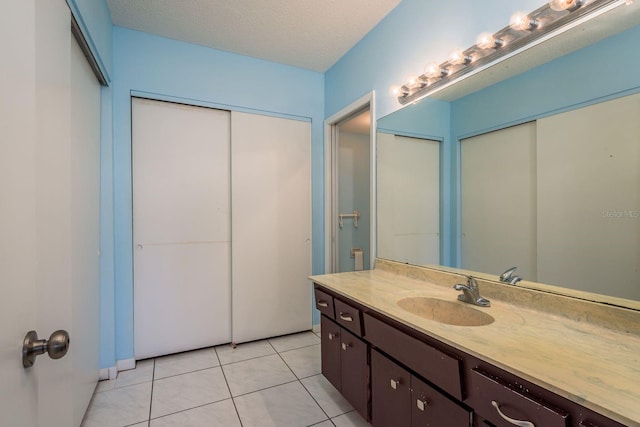 30 Turner St Unit 502, Clearwater, FL 33756 - bathroom with tile patterned floors, vanity, and a textured ceiling