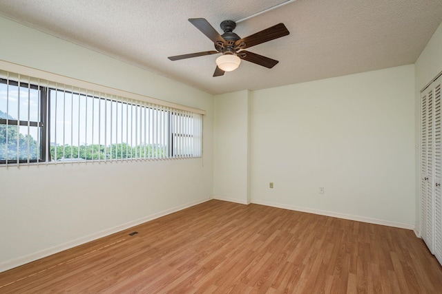 30 Turner St Unit 502, Clearwater, FL 33756 - empty room featuring baseboards, a ceiling fan, wood finished floors, and a textured ceiling