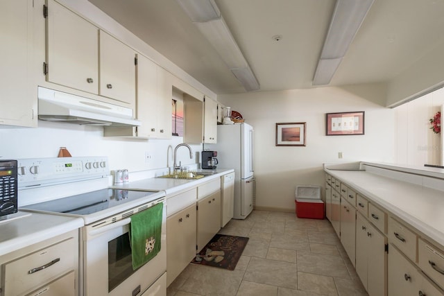 30 Turner St Unit 502, Clearwater, FL 33756 - kitchen featuring white appliances, light countertops, under cabinet range hood, and a sink
