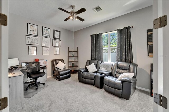 office featuring carpet, visible vents, baseboards, and a ceiling fan