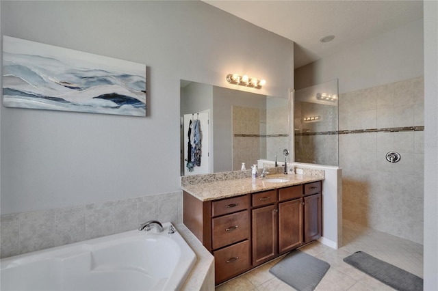 bathroom with a bath, tile patterned floors, vanity, and walk in shower
