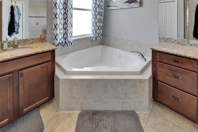 full bath featuring tile patterned floors, vanity, and a bath