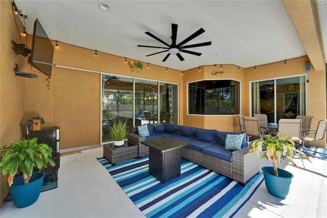 view of patio with an outdoor living space and ceiling fan