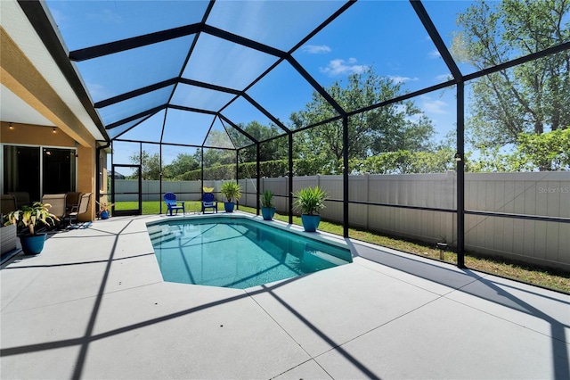 view of pool with a fenced in pool, a patio area, a fenced backyard, and glass enclosure