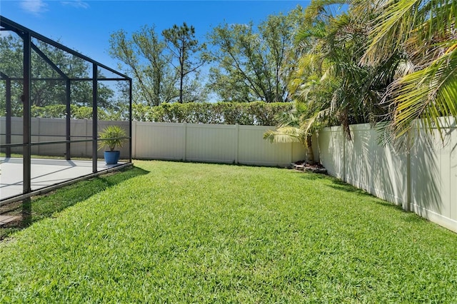 view of yard featuring a lanai and a fenced backyard