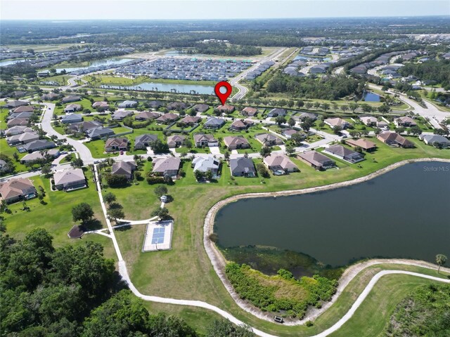 birds eye view of property with a residential view and a water view