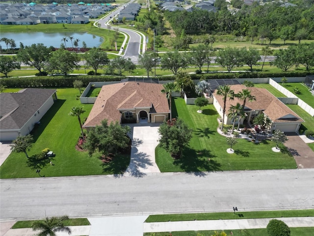 birds eye view of property with a water view and a residential view