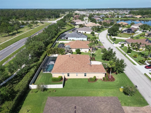 drone / aerial view featuring a water view and a residential view
