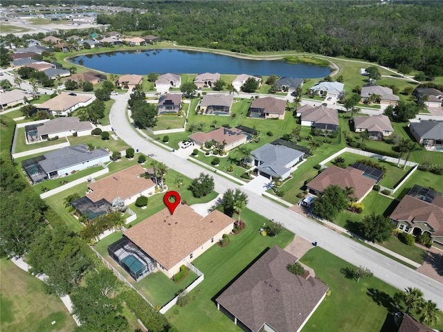 bird's eye view featuring a view of trees, a residential view, and a water view