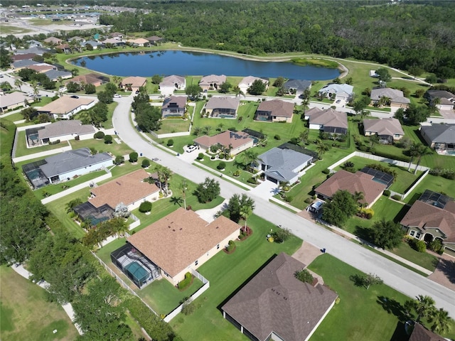 birds eye view of property featuring a water view, a residential view, and a view of trees