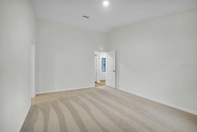 unfurnished room with light carpet, baseboards, and visible vents