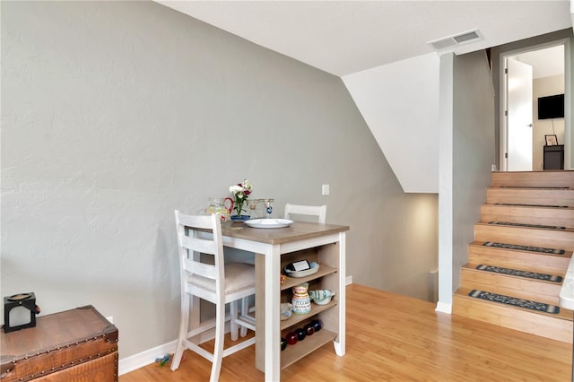 200 Meres Blvd Unit 7, Tarpon Springs, FL 34689 - dining room with wood finished floors, stairs, lofted ceiling, and baseboards