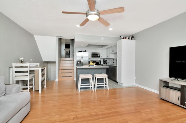 200 Meres Blvd Unit 7, Tarpon Springs, FL 34689 - living area with a ceiling fan, light wood-style flooring, baseboards, stairway, and recessed lighting