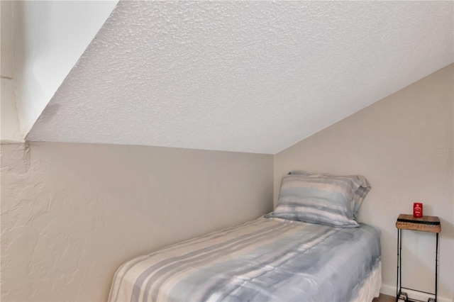 200 Meres Blvd Unit 7, Tarpon Springs, FL 34689 - bedroom featuring a textured ceiling and lofted ceiling