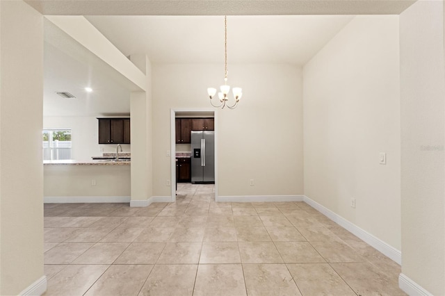 16302 Vine Cliff Ave, Hudson, FL 34667 - interior space with an inviting chandelier, light tile patterned floors, baseboards, a sink, and visible vents