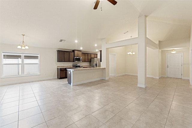 16302 Vine Cliff Ave, Hudson, FL 34667 - kitchen with appliances with stainless steel finishes, dark brown cabinetry, ceiling fan with notable chandelier, open floor plan, and light tile patterned floors