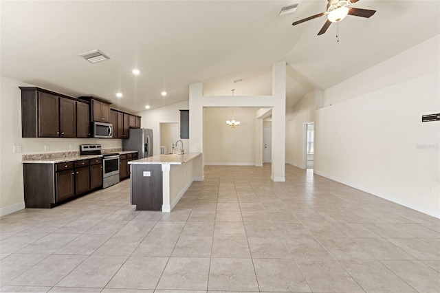 16302 Vine Cliff Ave, Hudson, FL 34667 - kitchen featuring open floor plan, ceiling fan with notable chandelier, visible vents, dark brown cabinets, and appliances with stainless steel finishes