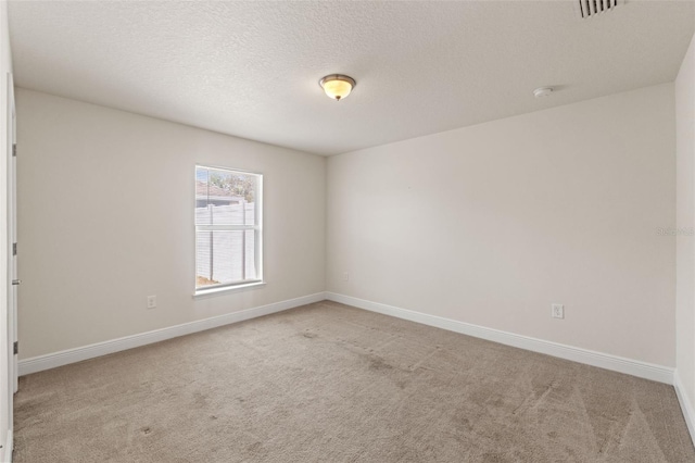 16302 Vine Cliff Ave, Hudson, FL 34667 - carpeted empty room featuring baseboards, visible vents, and a textured ceiling