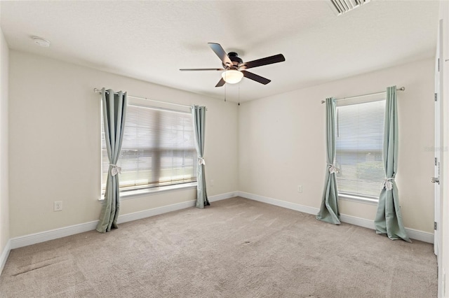 16302 Vine Cliff Ave, Hudson, FL 34667 - empty room with a ceiling fan, a wealth of natural light, light colored carpet, and visible vents