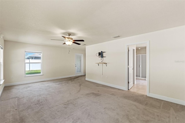 16302 Vine Cliff Ave, Hudson, FL 34667 - unfurnished room featuring a ceiling fan, a textured ceiling, baseboards, light colored carpet, and visible vents