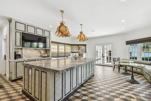 3313 W Mullen Ave, Tampa, FL 33609 - kitchen with french doors, a kitchen island, tasteful backsplash, decorative light fixtures, and recessed lighting