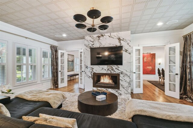 3313 W Mullen Ave, Tampa, FL 33609 - living room with ornamental molding, wood finished floors, and an inviting chandelier