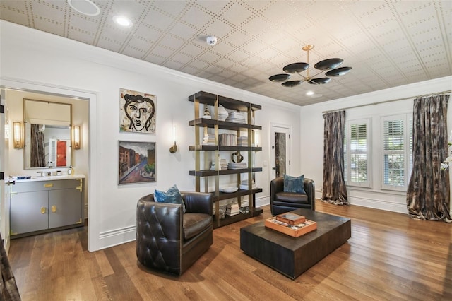 3313 W Mullen Ave, Tampa, FL 33609 - living area with an ornate ceiling, crown molding, wood finished floors, baseboards, and an inviting chandelier