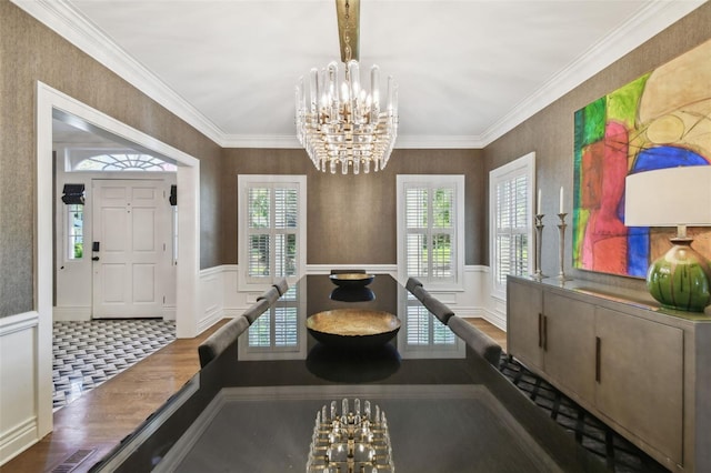 3313 W Mullen Ave, Tampa, FL 33609 - dining area featuring an inviting chandelier, ornamental molding, a wainscoted wall, visible vents, and wood finished floors