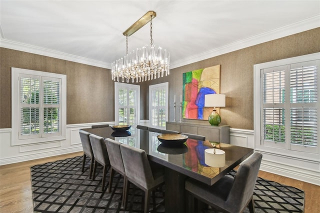3313 W Mullen Ave, Tampa, FL 33609 - dining room featuring a wainscoted wall, a healthy amount of sunlight, and a notable chandelier