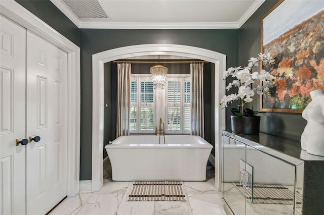 3313 W Mullen Ave, Tampa, FL 33609 - full bath with a soaking tub, crown molding, baseboards, marble finish floor, and an inviting chandelier