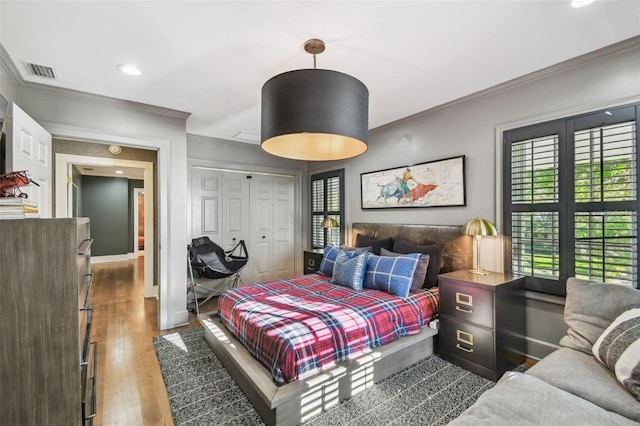 3313 W Mullen Ave, Tampa, FL 33609 - bedroom featuring multiple windows, visible vents, crown molding, and wood finished floors