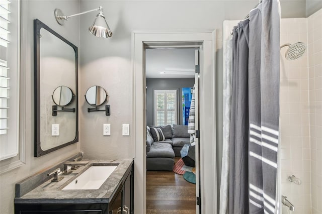 3313 W Mullen Ave, Tampa, FL 33609 - full bathroom featuring connected bathroom, wood finished floors, and vanity