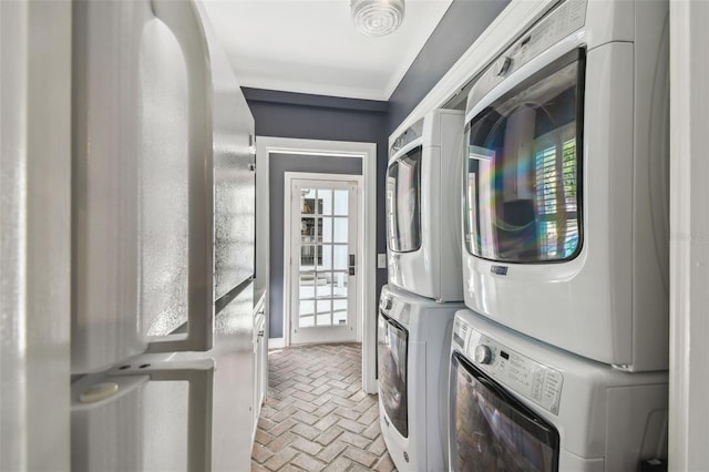 3313 W Mullen Ave, Tampa, FL 33609 - laundry room featuring laundry area, brick floor, stacked washing maching and dryer, and plenty of natural light